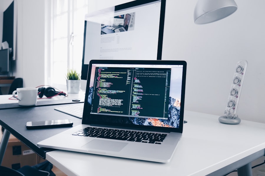 A laptop on a desk with code open on the screen.